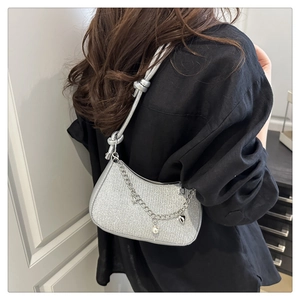 Detail of silver sequin crescent hobo bag with pearl chain and heart charm