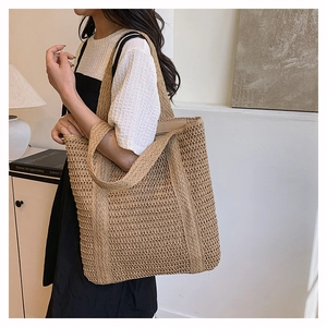 Detail of hand-woven straw tote bag showing fine texture and large capacity