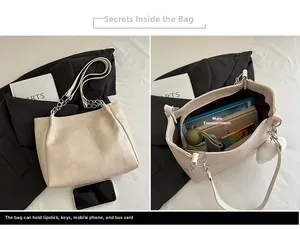 Macro view of beige tote bag showing large capacity interior with pompom detail