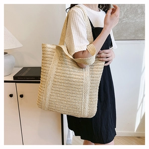 Detailed view of handmade woven hollow tote bag with wide strap for a vintage summer look