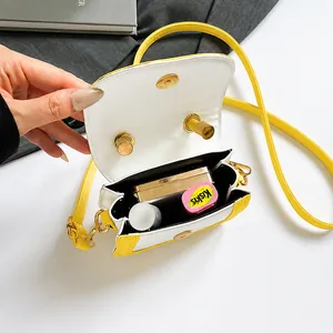 Macro view of the cream and yellow crossbody bag interior showing storage space
