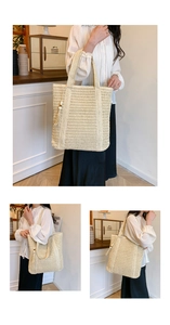 Detail of hand-woven beige straw tote bag featuring wooden bead tassels and long shoulder straps