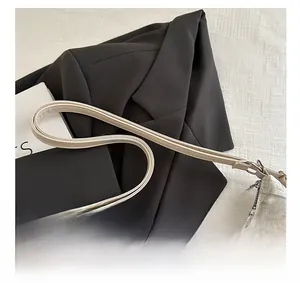 Detailed view of jacquard pattern texture and silver zipper on the crossbody bag