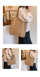Detail of hand-woven straw tote bag featuring tassel charm with wooden beads and long handle