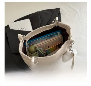Spacious interior of beige tote bag showing storage for tablet, notebook and umbrella