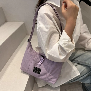 Lavender minimalist large nylon crescent tote bag shown on model with street style vibe