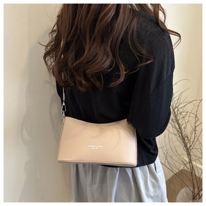 Close-up of nude leather bucket bag showing the Fashion & Bags Leather logo and slim strap