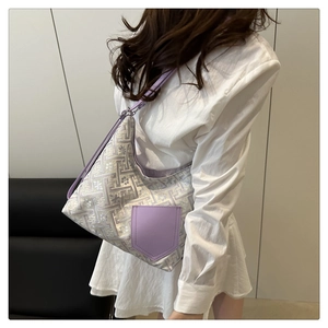 Detail of lavender floral texture fabric tote bag styled on model with a purple leather pocket