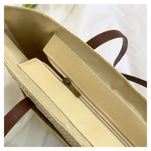 Detailed close-up of woven tote bag featuring canvas lining and secure zipper closure
