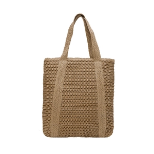 Minimalist beige woven straw tote bag with wide handles for beach vacation style