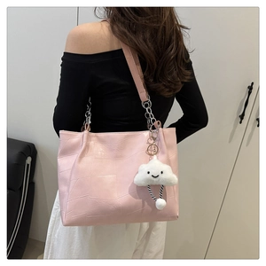 Detail of pink tote bag with geometric stitching and a cute white cloud charm