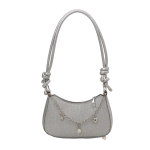 Silver sequin shoulder bag with decorative metal chain charms and knotted strap