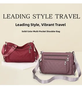 Detail of quilted rhombic cross-body bags in burgundy and purple with multiple zipper pockets
