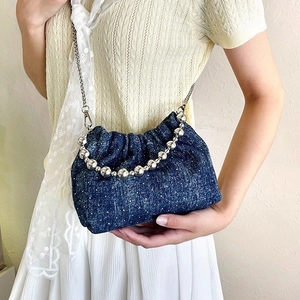Deep blue denim ruffle bucket bag with floral pattern and silver beaded handle
