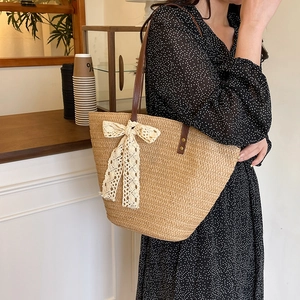 Fashion woven straw tote bag with a white lace bow and brown leather handles for women