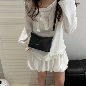 Chic black PU leather bucket bag with white typography strap and metal buckle accents