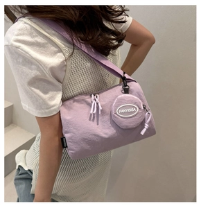 Detail of light purple nylon crossbody bag with matching round mini coin purse pouch