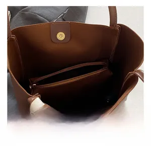 Detail of tote bag interior with magnetic closure and removable zipper pouch