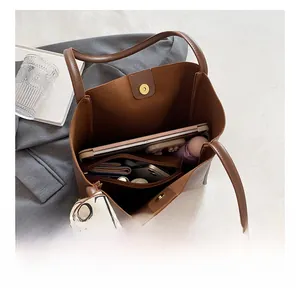 Interior view of the brown tote bag showing large capacity for tablet and daily items
