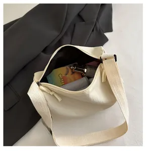 Detailed top view showing the spacious interior compartment of this cream canvas bag