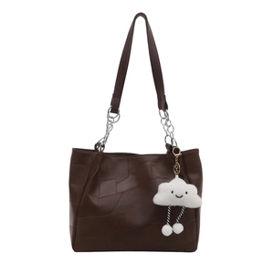 Vintage large brown tote bag with patchwork leather, chain strap, and plush charm