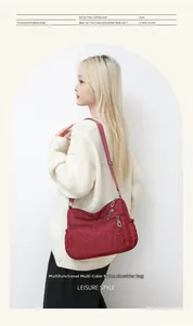 Macro detail of wine red nylon shoulder bag featuring heart pattern and functional pockets