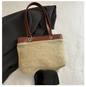 Detail of straw woven tote bag with brown leather handles and smartphone size comparison
