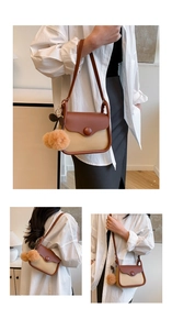Close-up of contrast color crossbody bag with brown flap and cute plush ball detail