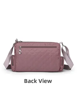 Detailed back view of quilted crossbody bag in dusty pink with horizontal zipper pocket