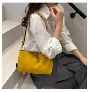 Detail of ginger canvas shoulder bag with dual zipper closure and FANVISSA brand label