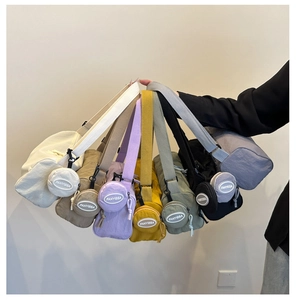 Detail of colorful cylindrical crossbody bags with matching round coin purses