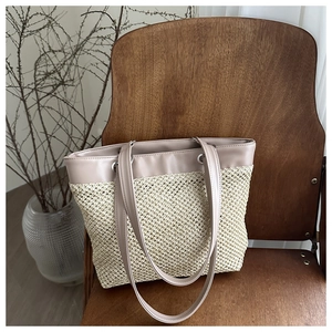 Detailed weave pattern and leather strap texture on a straw tote bag for summer
