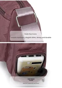 Detail of quilted crossbody bag with metal buckle and functional side zipper pocket