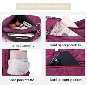 Detailed view of dark purple nylon shoulder bag with heart quilting and multiple pockets