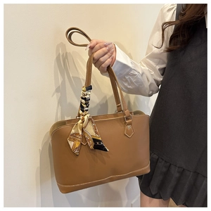 Caramel brown tote bag with decorative silk scarf and fine stitching details