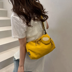 Minimalist ginger yellow nylon crossbody bag with small round coin purse pendant