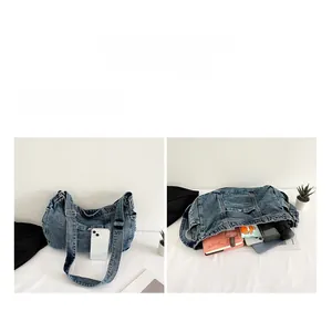 Detail view of large capacity denim messenger bag with multi-pocket storage layout