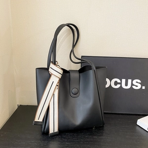 Minimalist black tote bag with decorative striped scarf and buckle closure for women