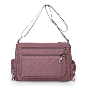 Quilted burgundy nylon crossbody bag with multi-pocket design and adjustable strap