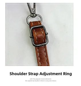 Detail of brown leather strap with adjustable buckle and lobster clasp hardware