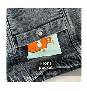 Detail of a denim bag front pocket with a silver button and functional loading space