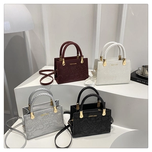 Close-up of four luxury stone-patterned crossbody bags in burgundy, white, silver and black