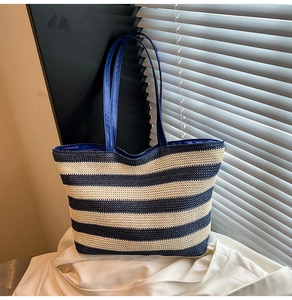 Close-up of blue and white striped woven tote bag with natural light and shadow