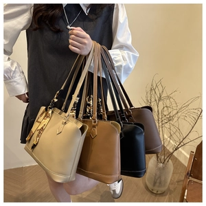 Detail of four chic tote bags in neutral colors with a stylish silk scarf accessory