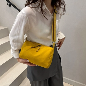 Large yellow solid color nylon crossbody bag with adjustable strap for sports and leisure