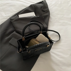 Chic black stone pattern crossbody bag with woven handles and golden metal rings