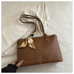 Detail of brown tote bag featuring fine white stitching and vintage floral silk scarf