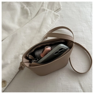 Top view of beige leather bucket bag interior showing space for phone and lipstick
