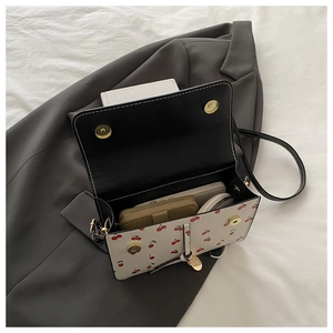 Détail du sac cerise montrant le rangement interne pour téléphone et porte-monnaie