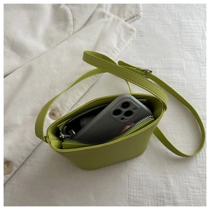 Mini avocado green bucket bag detail showing internal capacity for a smartphone
